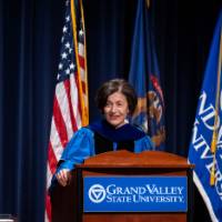 Provost Mili speaks at the podium